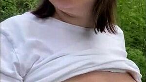 Public slut shows her big natural tits in the park